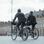 2 men riding on bicycle during daytime